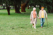© LIGHTFIELD STUDIOS - Smiling senior couple holding hands while walking in park