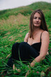 © Denis - Beautiful girl in black bra and long skirt sits in the grass