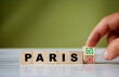 © daily_creativity - The hand turns the wooden cube and changes the word PARIS with red tick check box and red reject X check box.