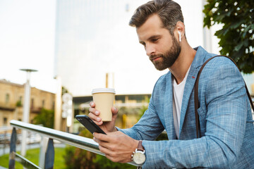 Wall Mural - Confident young business man walking outdoors