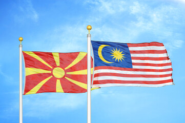 North Macedonia and Malaysia two flags on flagpoles and blue sky