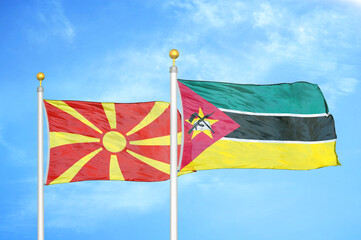 North Macedonia and Mozambique two flags on flagpoles and blue sky