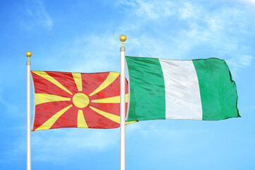 North Macedonia and Nigeria two flags on flagpoles and blue sky