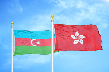 Azerbaijan and Hong Kong two flags on flagpoles and blue sky