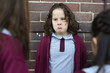 © Claire Bonnor/Austockphoto - A school girl listening to bullies in the playground