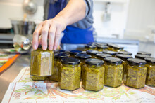 Jars Of Pickle Being Filled In Small Commercial Kitchen