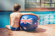 © Gillian Vann/Austockphoto - girl on the side of a swimming pool with an Australian flag ball
