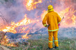 © Gary Chapman/Austockphoto - A fireman using a torch watching over a fuel reduction burn off