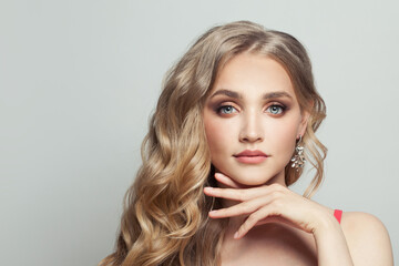 Wall Mural - nice woman with long blonde curly hair on white