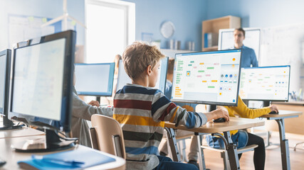 Wall Mural - elementary school computer science classroom: smart little schoolchildren work on personal computers
