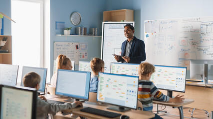 Wall Mural - elementary school computer science class: teacher uses digital tablet, explains lesson to diverse gr