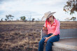 © Lisa Alexander/Austockphoto - Female farmer holding iPhone