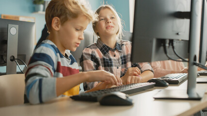 Wall Mural - elementary school computer science classroom: portrait of smart girl and boy talking while using per