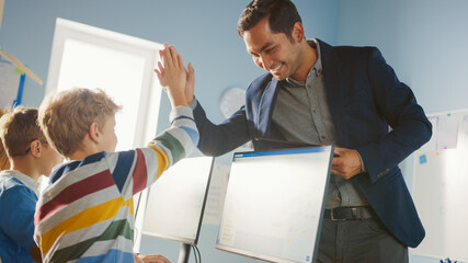 Wall Mural - elementary school computer science classroom: teacher uses tablet computer, explains lesson to diver