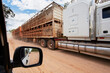 Cattle transport truck passes 4wd on dirt road.