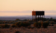 © Rosalie Dibben/Austockphoto - old water tank at sunrise with hills in background