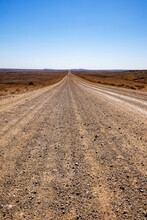 Stretch Of Dirt Road In Desert Landscape, Vertical