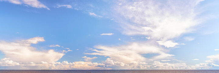 Wall Mural - panoramic cloudscape over sea at bright sunny day