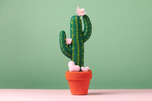 A Toy Felt Blooming Cactus With Cute Small Hearts Are On A Light Green Background. Concept Wedding Proposal, Gift, Mother's Day.