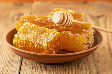 Wall Mural - jar of honey with honeycomb on wooden table