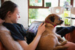 © Tom Merton/Caia Image - Girl with dog video chatting with friends on digital tablet screen