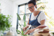 © Sam Edwards/Caia Image - Smiling woman cooking at digital tablet in kitchen