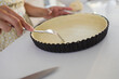 © Sam Edwards/Caia Image - Close up woman baking poking holes into pie crust with fork