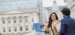 © Paul Bradbury/Caia Image - Business people using laptop on city bridge