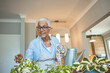 © Dragana Gordic - Active senior woman enjoying planting. Senior woman planting flowers. Senior woman plant care at home. Portrait Of Happy Mature Arranging Potted Plants