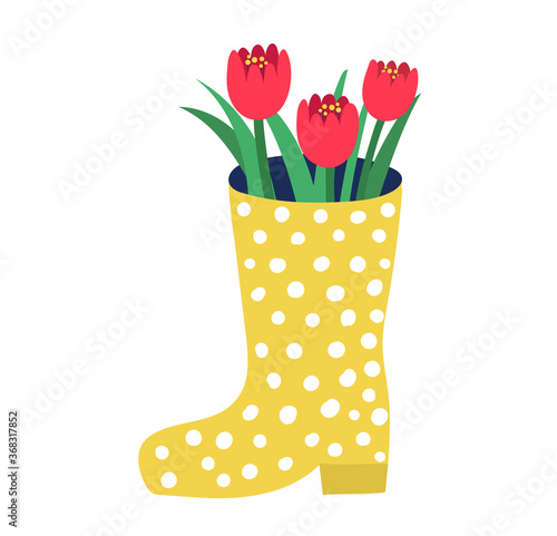Yellow rubber boots with red garden flower springtime mood, spring rose flore...