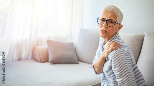Senior woman with shoulder pain. Elderly woman is enduring awful ache. Shoulder Pain In An Elderly Person. Senior lady with shoulder pain. Close up of sad senior lady with neckache