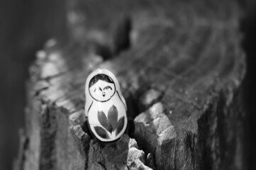 Wall Mural - A small matryoshka doll on a wooden background.