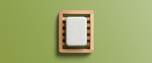 White Bar Of Soap In Wooden Dish On A Green Background. Directly Above, Copy Space.