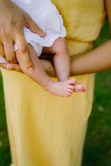 Wall Mural - Mother holding her child wearing a yellow dress 