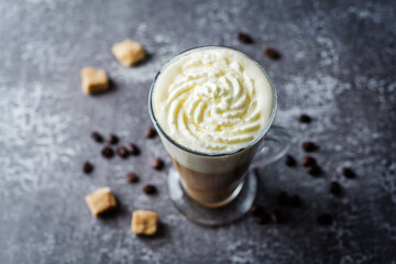 Wall Mural - Coffee with whipped cream in a glass with coffee beans