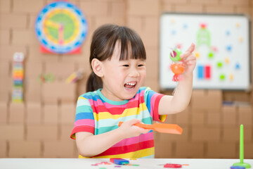 Wall Mural - young  girl  play magical magnet experiments at home for homeschooling