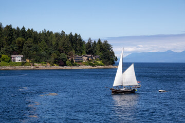 Sailboat in the Ocean by the City of Nanaimo during a sunny summer day. Taken in Vancouver Island, British Columbia, Canada.