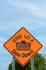 Sign that says to Slow Down and Give Us a Brake