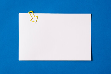 white sheet of paper for notes and paper clip
