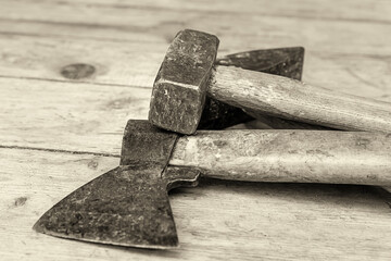 old ax hammer construction tool tinted set lies on a wooden table closeup