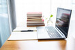 © Lili.Q - Laptop and book study materials on the desk