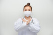© makistock - A young beautiful woman doctor in a white coat shows a stop gesture on white background. Say No virus disease.