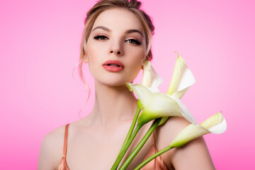 Wall Mural - elegant beautiful blonde woman holding calla flowers isolated on pink