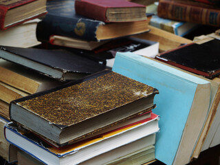 Sticker - Closeup of the pile of old books stacked on top of each other