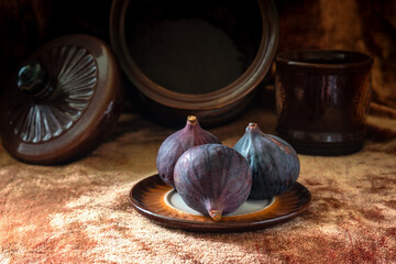 Wall Mural - Ripe figs in a plate on the table.