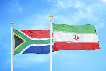 South Africa and Iran two flags on flagpoles and blue sky