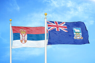 Serbia and Falkland Islands two flags on flagpoles and blue sky