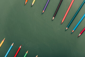 Canvas Print - rows of color pencils on green chalkboard, top view