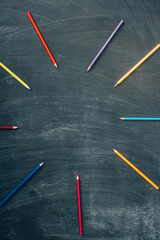 Canvas Print - top view of empty frame of multicolored pencils on green chalkboard