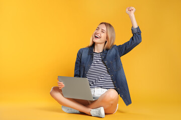 Sticker - Emotional young woman with laptop on yellow background